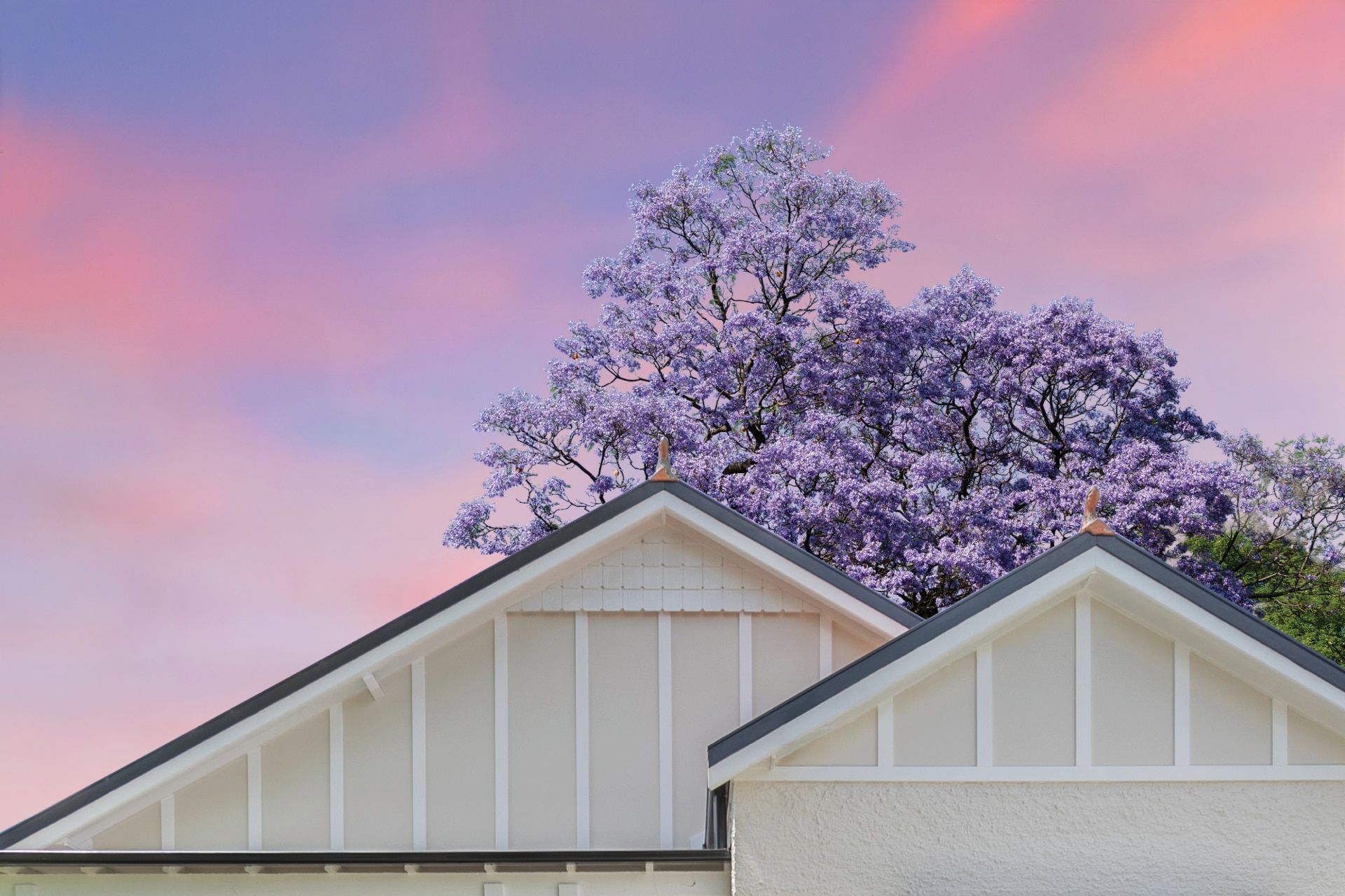 Plane flying over a house at sunset