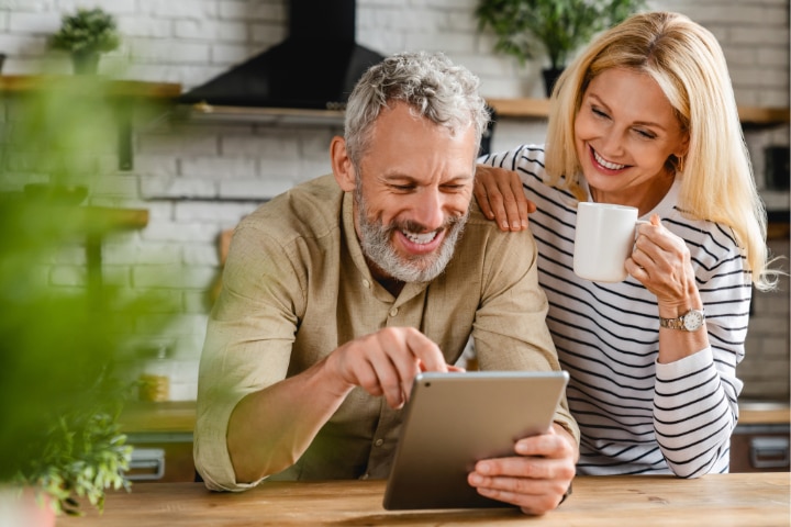 man and a woman looking at an ipad