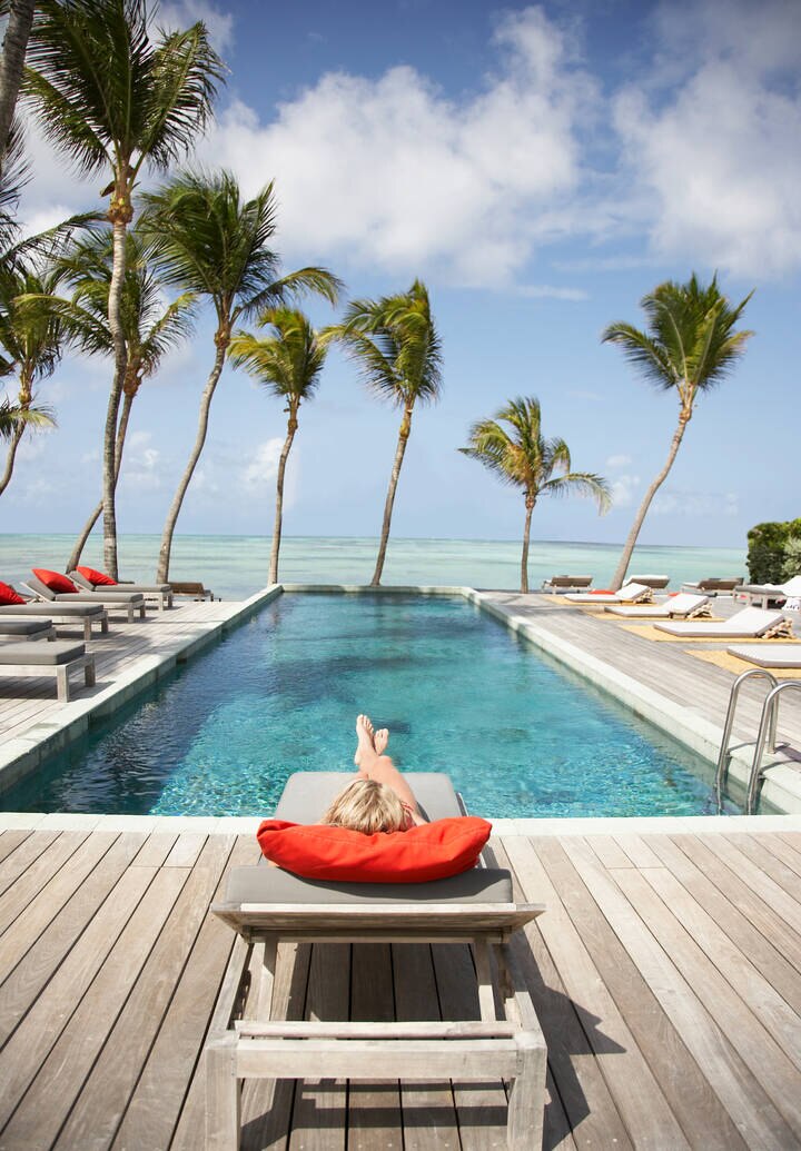 Image of woman on sun bed by hotel pool