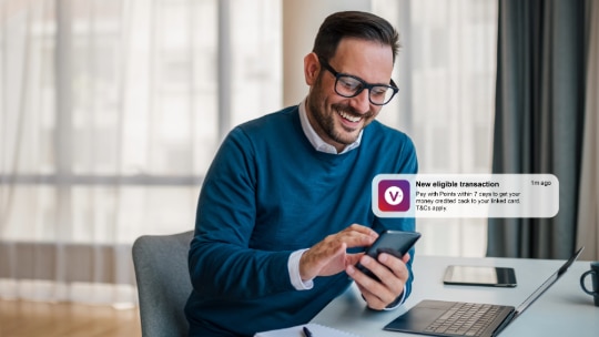 Image of a man paying for an onboard purchase