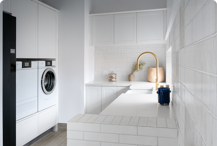 Image of white tiled laundry room by Freedom Kitchens and Wardrobes