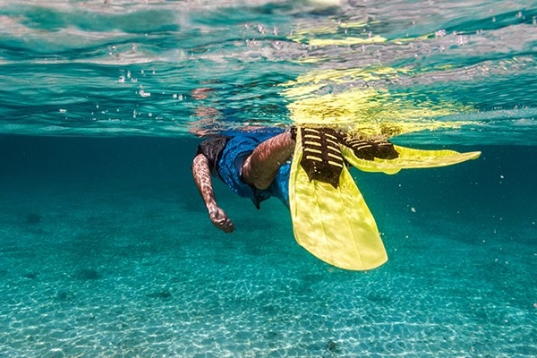Image of person swiming in water with flippers on