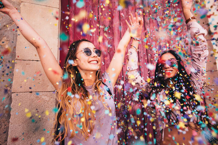 Two girls celebrating with confetti 