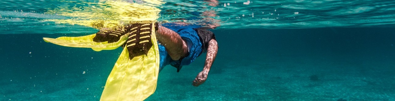 Man snorkelling in clear blue water